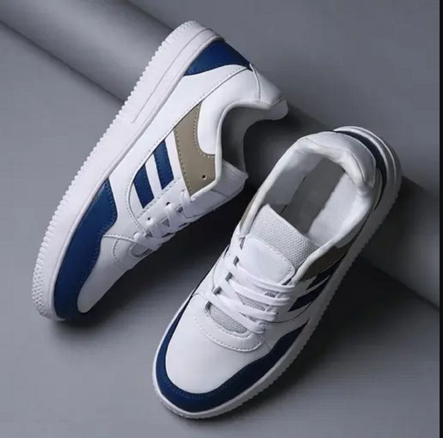 White sneakers with blue accents on a gray background